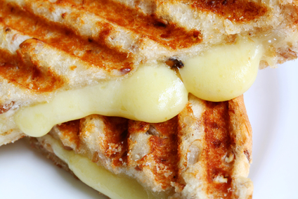 Closeup of melting cheese in a grilled cheese sandwich on wholewheat bread.  With grill marks.