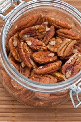 Fresh Pecan nuts in an open glass jar