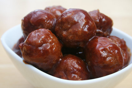 Close  up of glazed meatballs in a white bowl