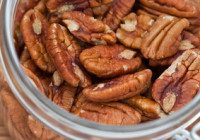 Fresh Pecan nuts in an open glass jar