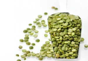 Dry Green Peas In A Measuring Spoon